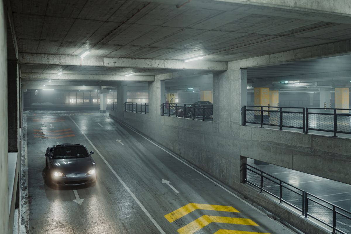 Rangée de box fermés dans un parking sous-sol d'immeuble résidentiel