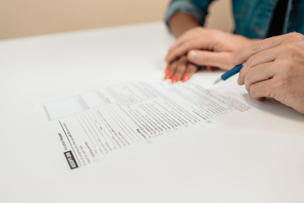 Maison familiale et documents de succession immobilière posés sur une table